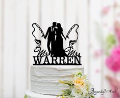 a wedding cake topper with the bride and groom holding hands