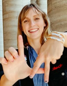 a woman making the peace sign with her fingers