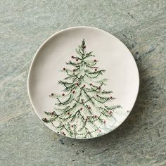 a white plate with a christmas tree painted on it