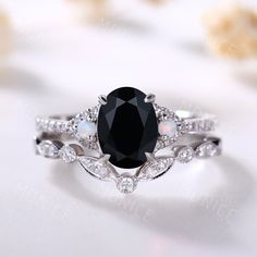 an oval black diamond surrounded by white diamonds