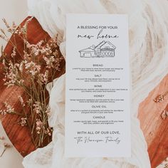 a menu card on top of a table next to flowers