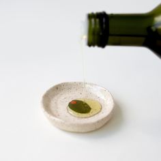 a small white bowl filled with olive oil