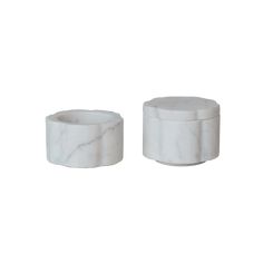 two white marble containers sitting next to each other