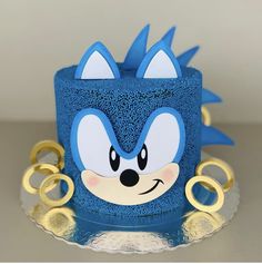 a blue cake decorated with an image of sonic the hedgehog's face on it