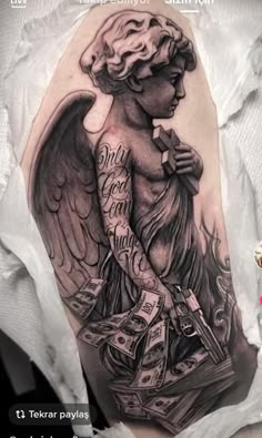 an angel with money on his arm is shown in this tattoo design by tattoostuffs