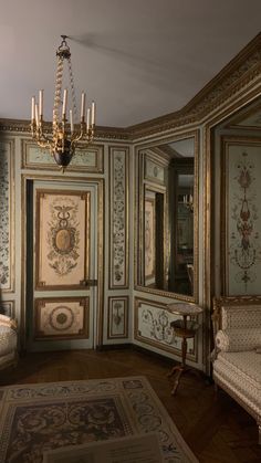 an ornately decorated room with chandelier and mirror