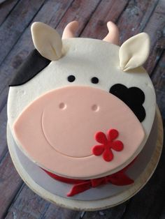 a cake shaped like a cow on top of a wooden table