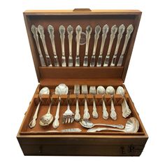 a wooden box filled with lots of silverware