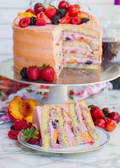 there is a cake with fruit on the top and one slice has been cut from it