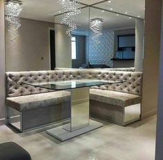 a large mirror sitting above a couch in a living room under a chandelier