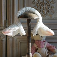 two stuffed animals are sitting on a stand