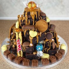 a cake made to look like a pile of brownies with candy and candies on top