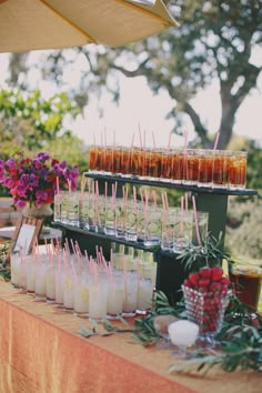 there are many drinks on the table with strawberries