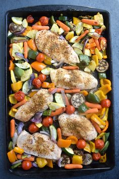 chicken and veggies on a sheet pan ready to be cooked in the oven