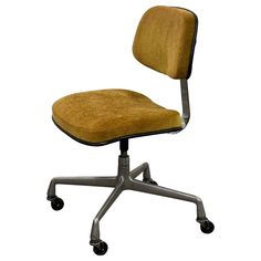 an office chair with wheels and a yellow upholstered fabric seat cover on the back