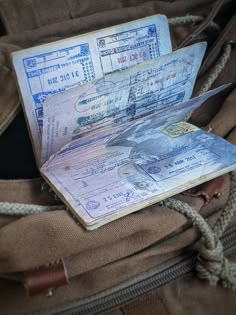 an old passport sitting on top of a backpack