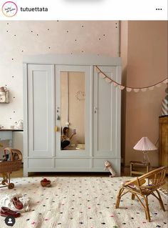 a child's bedroom with an armoire and toys on the floor in front of it