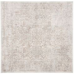 an antique style rug in beige and white tones with faded edges, on a white background