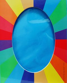 a rainbow colored paper with a blue circle in the center and white border around it