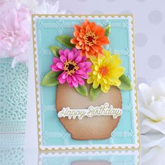 a happy birthday card with flowers in a vase on top of the card is shown