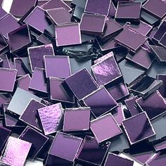 purple glass mosaic tiles are scattered on the floor