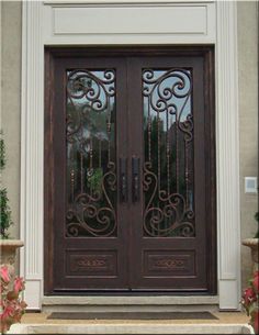 the front door is decorated with flowers and wrought iron designs on it's sides