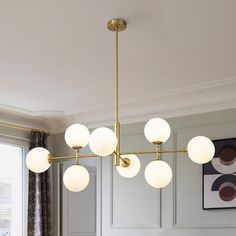 a chandelier hanging over a dining room table