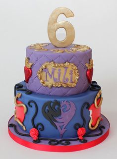 a birthday cake that has the number six on it and is decorated in blue, purple, red and gold