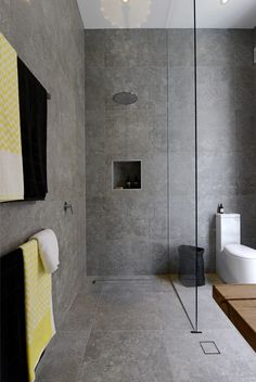 a bathroom with a shower, toilet and sink