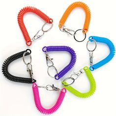 six different colored dog leashes are shown in the shape of heart shaped rings with metal hooks