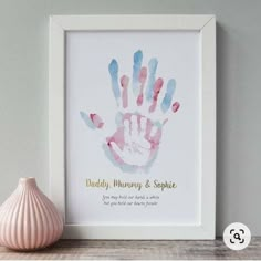 a pink and blue hand print with the words daddy, mommy & sophiie