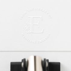 a close up of a typewriter on a desk with the e logo above it