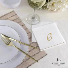 a place setting with napkins, silverware and flowers