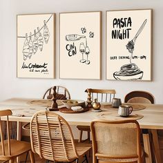 three posters on the wall above a dining room table with chairs and place settings in front of them