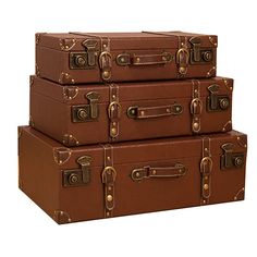 three brown suitcases stacked on top of each other in front of a white background