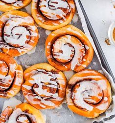 cinnamon rolls with icing on a baking sheet