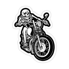 a skeleton riding on the back of a motorcycle