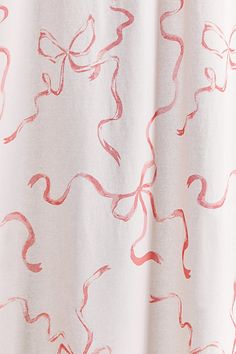 a white curtain with pink and red designs on it