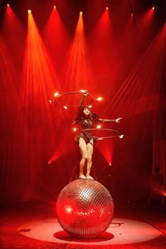 a woman standing on top of a disco ball