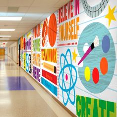 the hallway is decorated with colorful wallpapers and school related art on it's walls