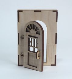 an open wooden door with a small window on the inside and outside, in front of a white background