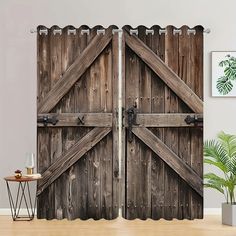 two wooden doors are open on the wall next to a table and potted plant