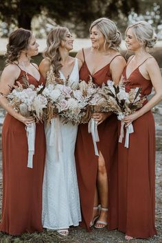 the bridesmaids are all wearing brown dresses and holding bouquets in their hands