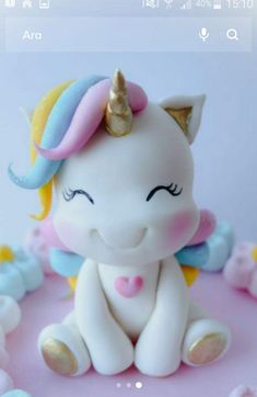 a small toy unicorn sitting on top of a table