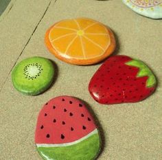 four different fruits are sitting on the floor