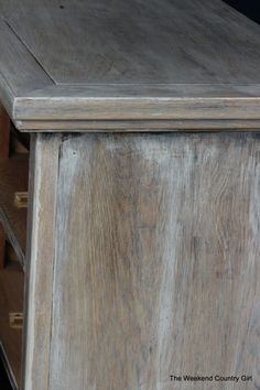 an old wooden cabinet with a clock on it