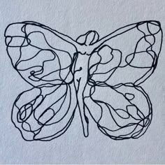 a black and white drawing of a butterfly on a piece of paper that has been drawn