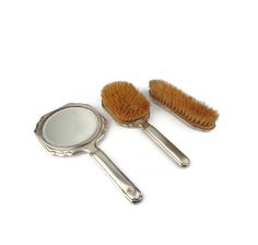 A great engraved painted brass makeup tool set - mirror and 2 brushes Found in France dimensions - mirror - 9.6''/24.5 cm - length 4.8''/12 cm - width brush - 9.4''/23.5 cm - length 3.2''/8 cm - width brush - 7''/17.5 cm - length 2.2''/5.5 cm - width 0.380 kg - weight set The set has signs of use, small deformations and in some places the silver coating has been erased. See the pictures, they are part of the product description! Vintage Brush Set, Vintage Hair Brush Set, Vintage Brush And Mirror Set, Antique Brush And Comb Set, Vintage Lipstick Holder With Mirror, Weight Set, Clothes Set, Travel Set, Hand Mirror