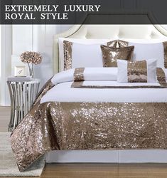 a bed with gold sequins and pillows on top of it in a room