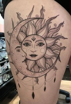 a woman's thigh with a sun and moon tattoo on it